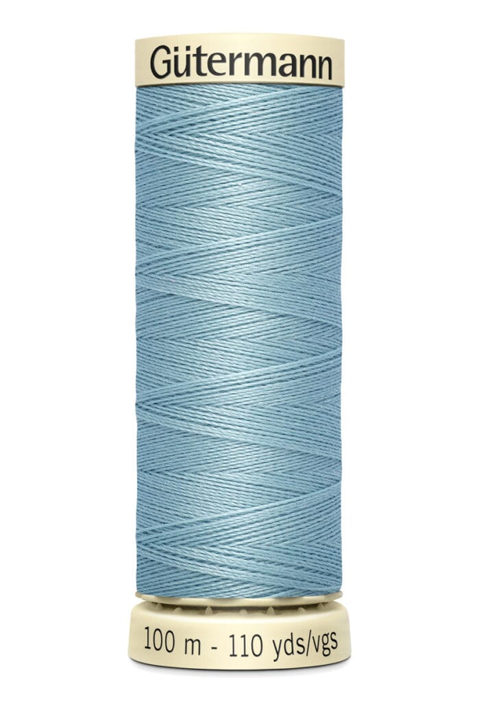 A spool of Gütermann sewing thread in light blue, labeled with "100 m - 110 yds/vgs" and "Gütermann" on the top and bottom.