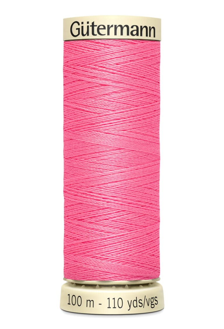 A spool of Gütermann thread in bright pink, with measurements of 100 meters and 110 yards printed on the label. The spool is upright, showing the thread wound neatly around it.