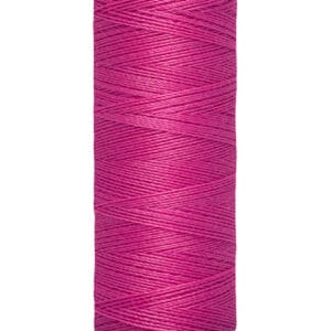 A spool of Gütermann thread in vibrant pink, containing 100 meters or 110 yards of thread. The spool is cylindrical and labeled with the brand name and thread length.