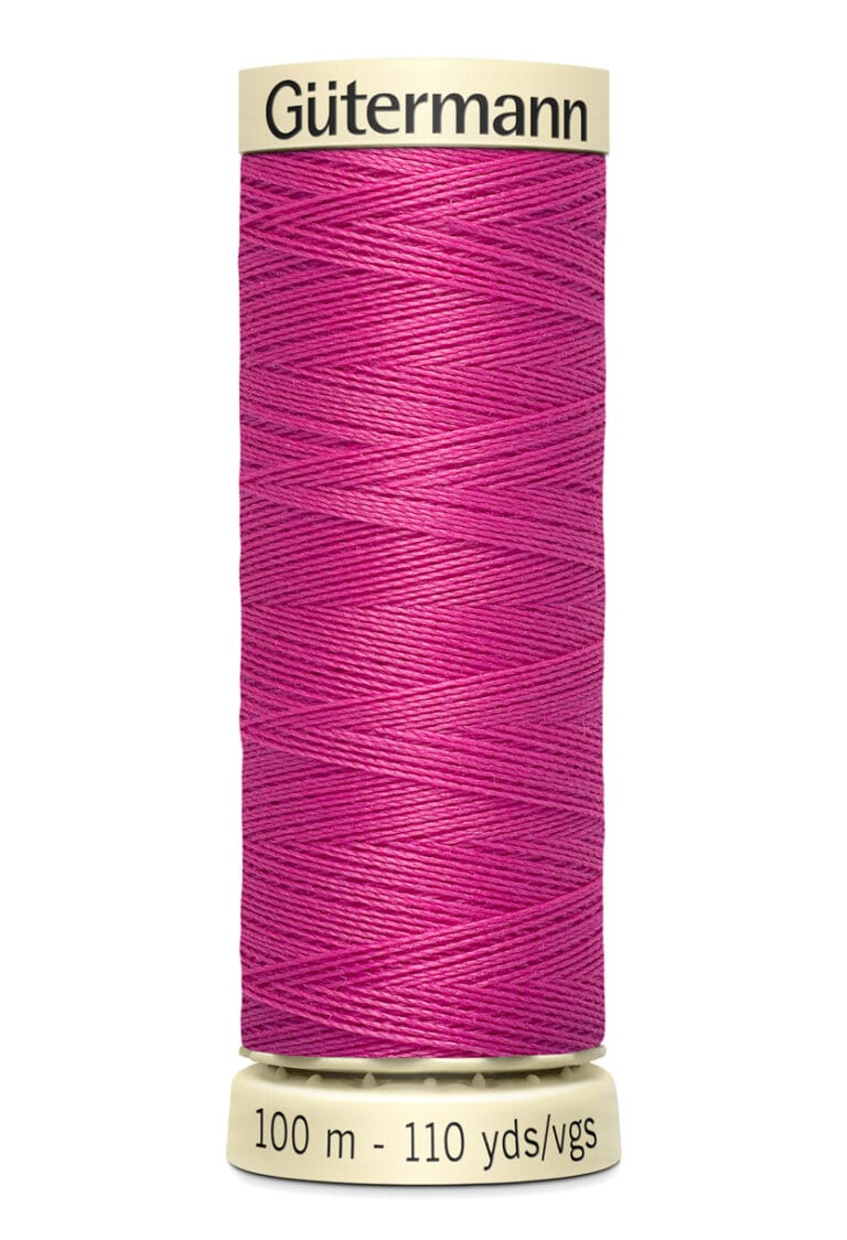 A spool of Gütermann thread in vibrant pink, containing 100 meters or 110 yards of thread. The spool is cylindrical and labeled with the brand name and thread length.