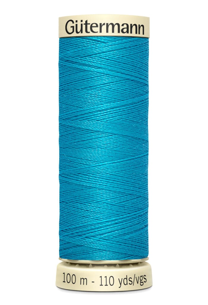 Spool of Gütermann thread in vibrant turquoise color, labeled with a length of 100 meters or 110 yards. The spool has a cream-colored top and base.