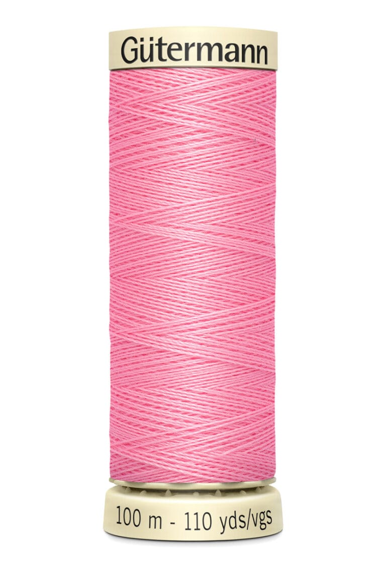 A spool of Gütermann pink sewing thread, labeled with 100 meters and 110 yards on the base.