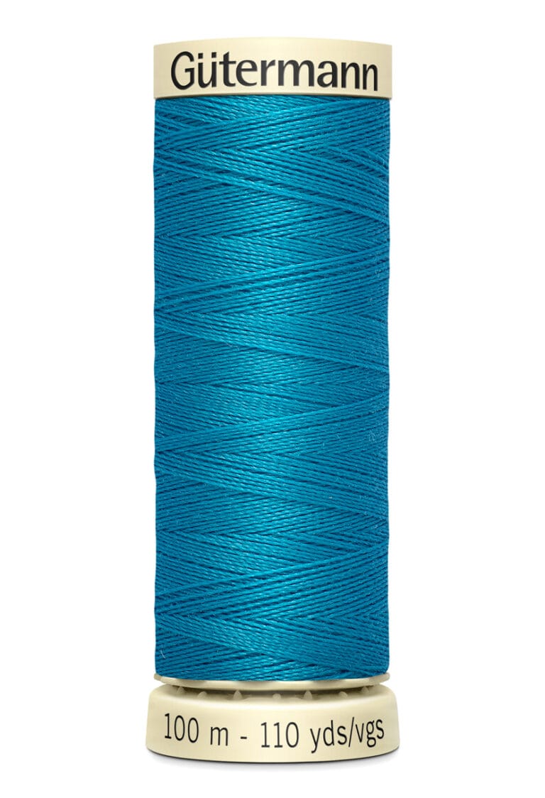 A spool of Gütermann sewing thread in vibrant teal is shown. The spool indicates it contains 100 meters or 110 yards of thread. The top and bottom of the spool are a cream color, contrasting with the blue thread.