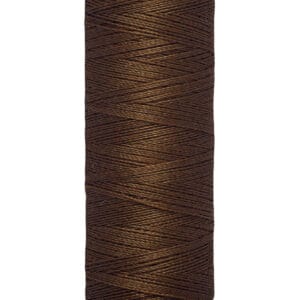 A spool of Gütermann brown thread, labeled with "100 m - 110 yds/vgs," against a white background. The spool has a beige top and bottom with the brand name in black.
