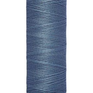 A spool of Gütermann thread in blue, wound tightly with a smooth appearance. The spool label reads "100 m - 110 yds/vgs," and the top label displays the brand name.