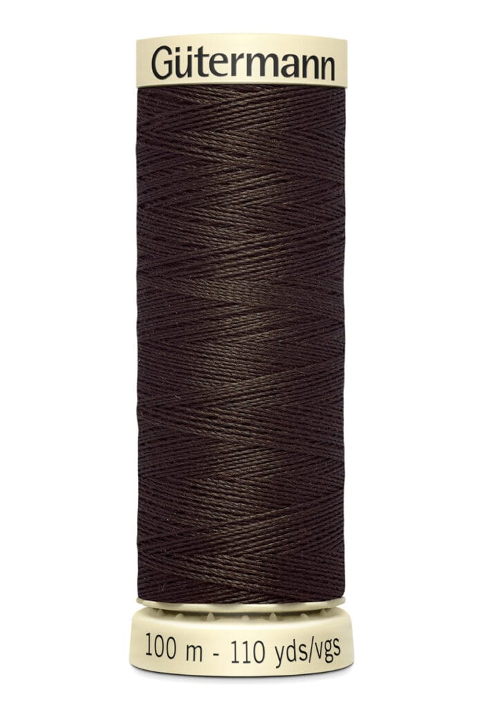 A spool of Gütermann dark brown thread, labeled "100 m - 110 yds/vgs," is shown upright against a white background.