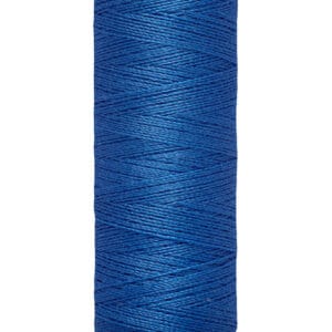 A spool of Gütermann blue sewing thread with labels indicating it contains 100 meters or 110 yards. The thread is coiled neatly on a beige spool with branded labels at the top and bottom.