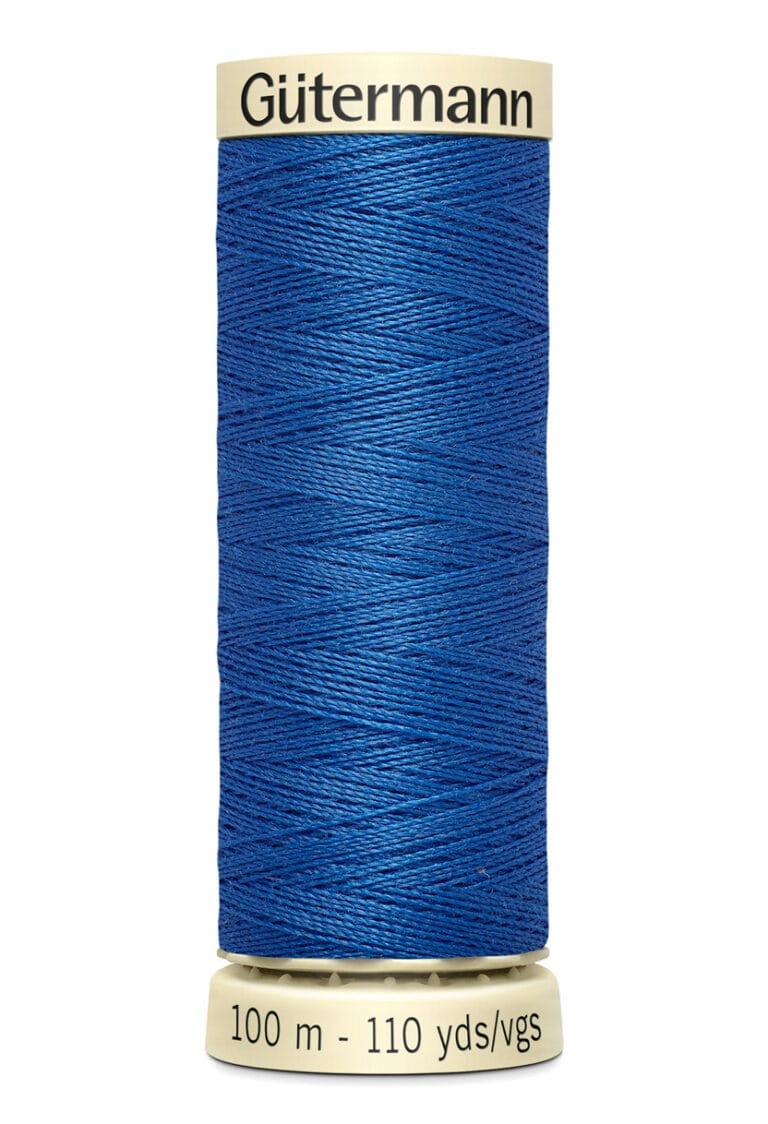 A spool of Gütermann blue sewing thread with labels indicating it contains 100 meters or 110 yards. The thread is coiled neatly on a beige spool with branded labels at the top and bottom.