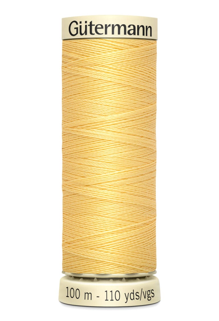 A spool of Gütermann light yellow sewing thread. The label indicates 100 meters or 110 yards.