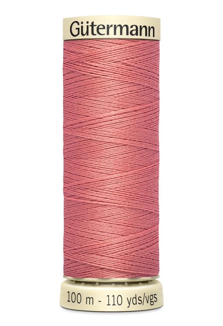 Spool of Gütermann sewing thread in a dusty rose color, wrapped around a beige cylinder. The label at the top reads “Gütermann,” and the base indicates the length as 100 meters or 110 yards.