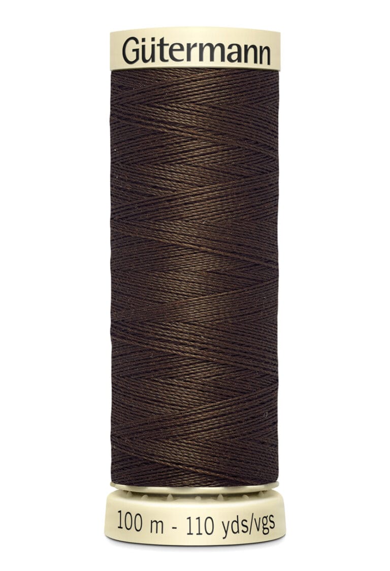 A spool of Gütermann sewing thread in dark brown, wound tightly with 100 meters or 110 yards of thread. The spool is cream-colored at the top and bottom with labels indicating the brand and length of the thread.