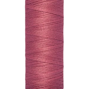 A spool of Gütermann thread in a shade of dusty pink. The spool label indicates the length as 100 meters or 110 yards.