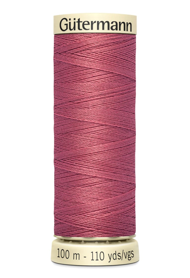 A spool of Gütermann thread in a shade of dusty pink. The spool label indicates the length as 100 meters or 110 yards.