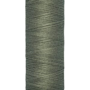 A spool of Gütermann thread in olive green, with labels indicating "100 m - 110 yds/vgs." The thread is uniformly wound on a beige spool.