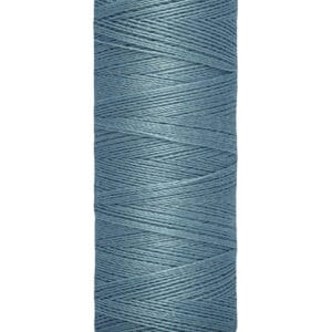 A spool of Gütermann thread in blue, with cream-colored top and bottom caps. The label indicates the thread is 100 meters (110 yards) in length. The thread is neatly wound around the spool.