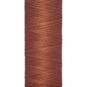 A light brown spool of Gütermann sewing thread, labeled with "100 m - 110 yds/vgs" on the bottom.