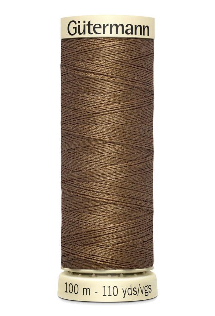 A spool of Gütermann sewing thread in brown color, with a length of 100 meters (110 yards). The spool is cylindrical and labeled at the base with the thread length.