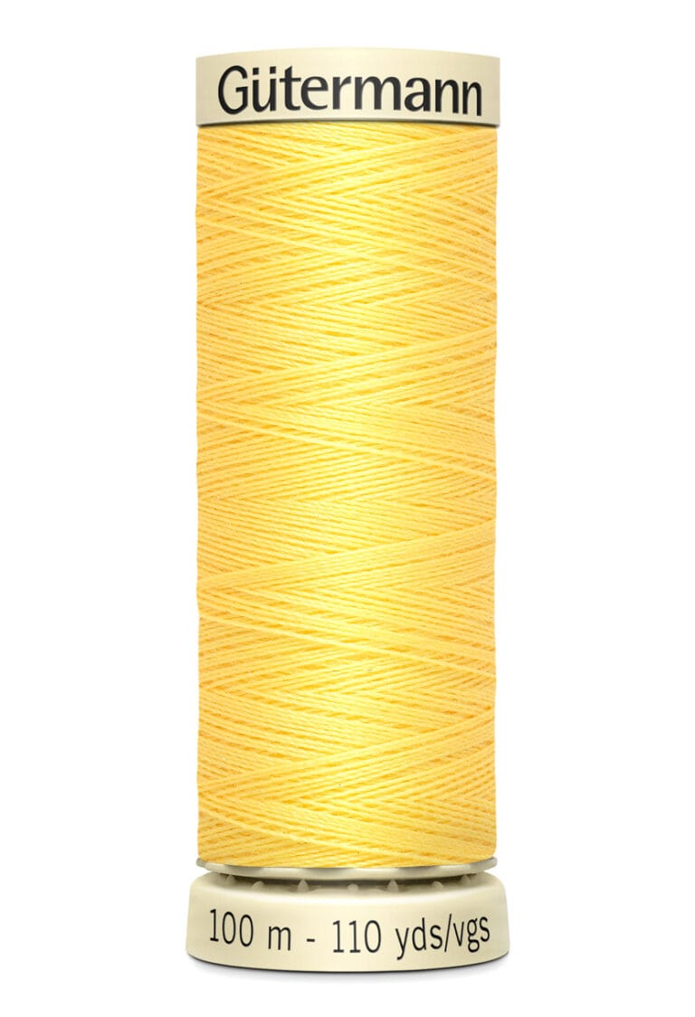 Yellow spool of Gütermann thread with 100 meters or 110 yards of thread.