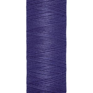 Spool of Gütermann thread in deep purple color, labeled with "100 m - 110 yds/vgs" and "Gütermann" on a cream-colored base and top.