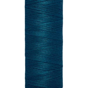 A spool of Gütermann thread in dark teal color. The label indicates it contains 100 meters or 110 yards of thread. The spool is cylindrical and stands upright.