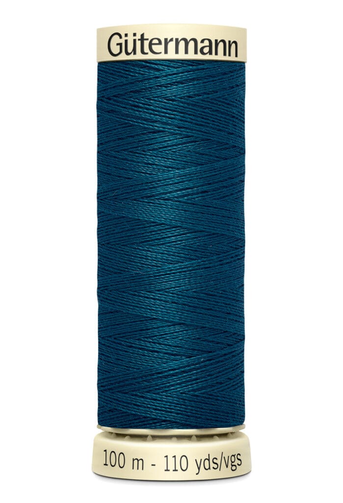 A spool of Gütermann thread in dark teal color. The label indicates it contains 100 meters or 110 yards of thread. The spool is cylindrical and stands upright.
