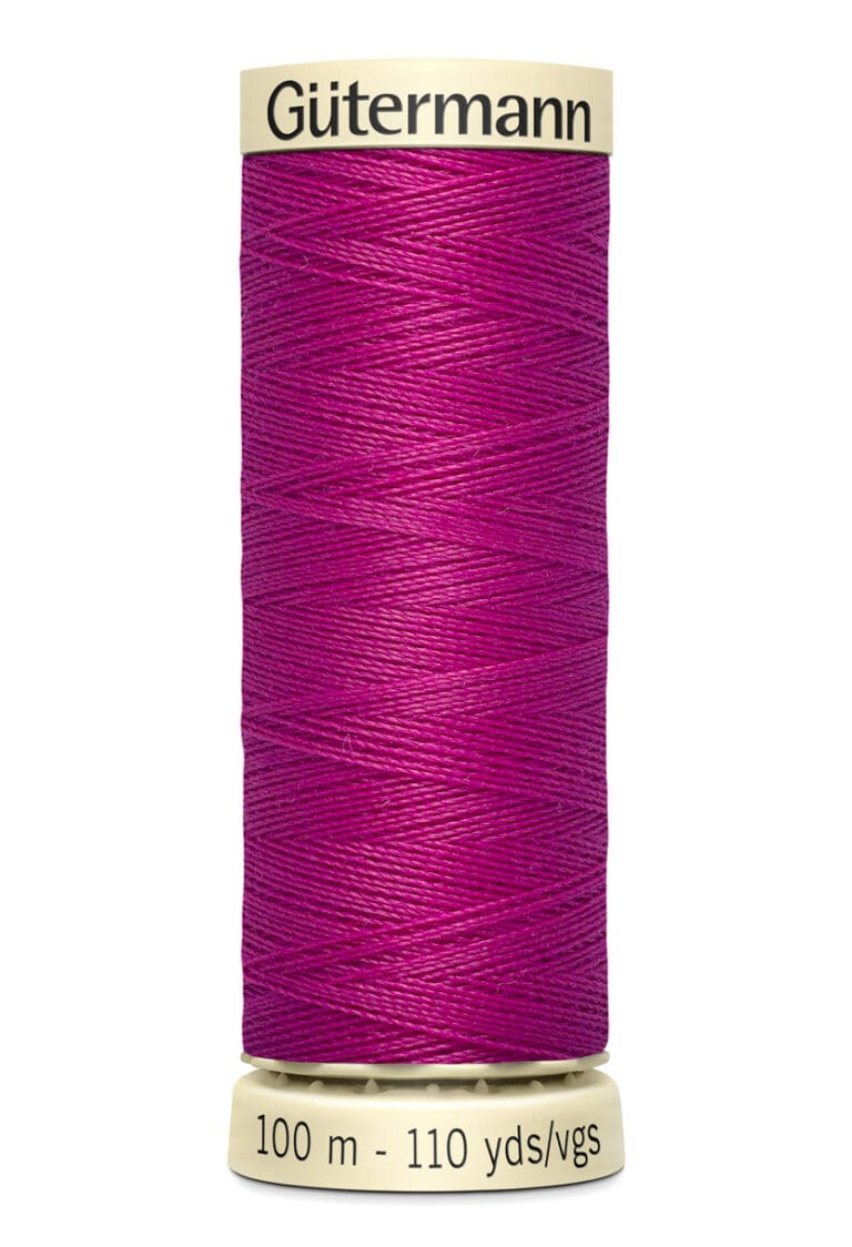 Spool of Gütermann sewing thread in a vibrant magenta color. The label indicates a length of 100 meters or 110 yards.