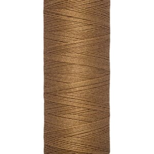 A spool of Gütermann brown sewing thread, labeled with measurements of 100 meters and 110 yards. The spool has a cream-colored base and top with the brand name printed on it.