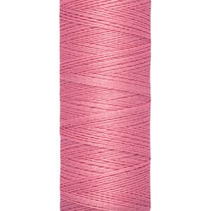 A spool of Gütermann sewing thread in pink, wrapped uniformly around a beige cylindrical holder. The base has "100 m - 110 yds/vgs" printed on it, indicating the thread length.