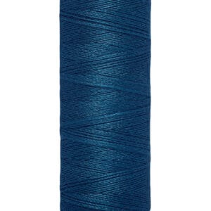 A spool of Gütermann thread in dark blue, wound tightly on a cream-colored holder. Text on the holder reads "100 m - 110 yds/vgs," indicating the length of the thread.