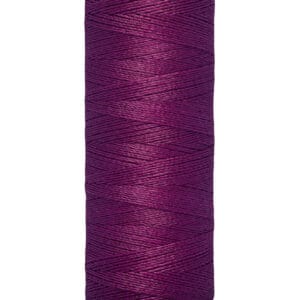 A spool of Gütermann thread, colored in deep purple, with 100 meters or 110 yards labeled on the bottom.