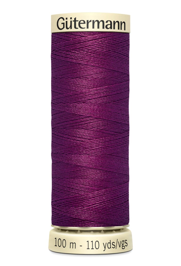 A spool of Gütermann thread, colored in deep purple, with 100 meters or 110 yards labeled on the bottom.