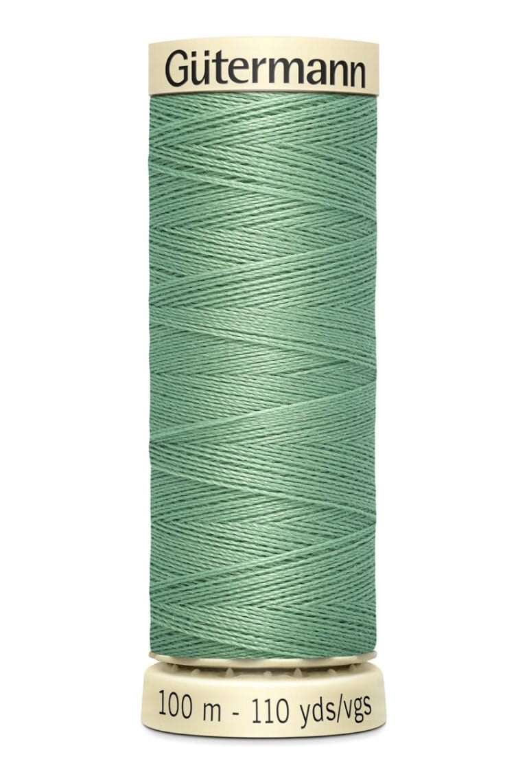 A spool of Gütermann sewing thread in a teal color. The spool shows "100 m - 110 yds/vgs" indicating the length of the thread. It has a beige top and bottom.