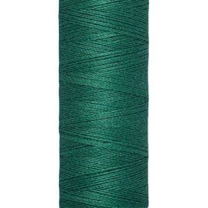 A spool of Gütermann sewing thread in emerald green. The spool is beige with black text that reads "Gütermann" on the top and "100 m - 110 yds/vgs" on the bottom. The thread is neatly wound around the spool.