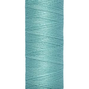A spool of Gütermann thread in teal blue. The label shows the length as 100 meters or 110 yards. The spool is set against a white background.