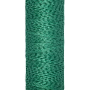 A spool of Gütermann green sewing thread, labeled 100 meters - 110 yards. The spool is cylindrical with a beige top and bottom, displaying the brand name at the top. The thread is neatly wound around the spool.