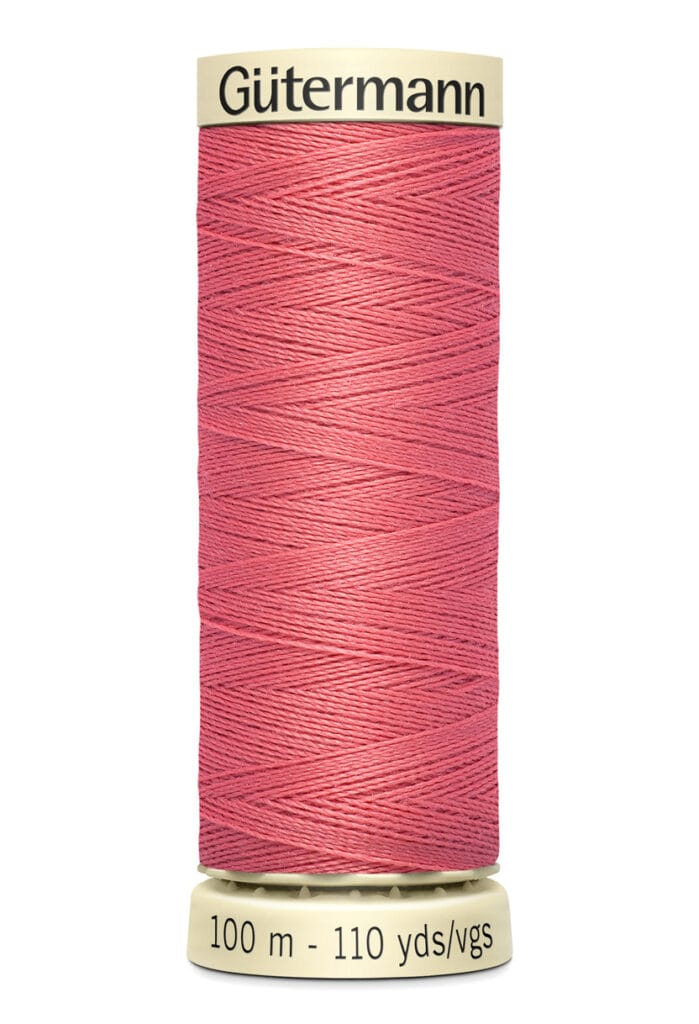 A spool of Gütermann pink sewing thread, labeled with 100 meters or 110 yards.