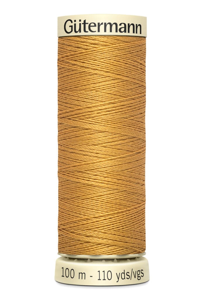 A spool of Gütermann sewing thread in a warm tan color, labeled with "100 m - 110 yds" at the base.
