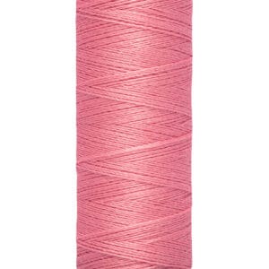 A spool of Gütermann thread, featuring a light pink color. The spool is labeled with measurements "100 m" and "110 yds/vgs" on a beige base, with the brand name at the top.