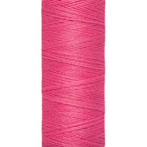 Spool of Gütermann pink sewing thread, labeled 100 meters, 110 yards.