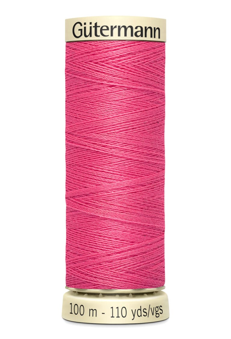 Spool of Gütermann pink sewing thread, labeled 100 meters, 110 yards.