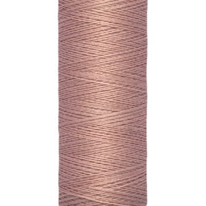 A spool of Gütermann thread is displayed, featuring a soft pink color. The spool is marked with 100 meters and 110 yards.