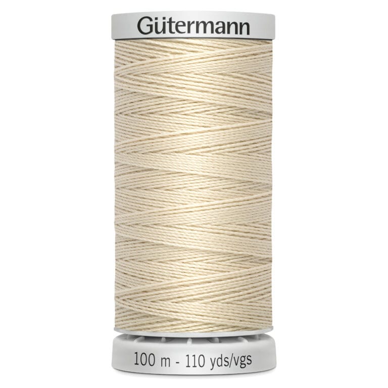 A spool of Gütermann sewing thread, beige in color. The label indicates it's 100 meters or 110 yards in length. The thread is neatly wound and the label is white with black text.