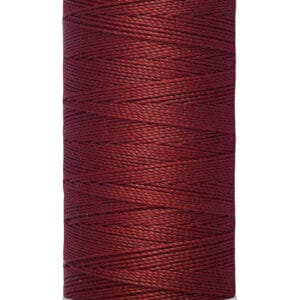 A spool of Gütermann thread with a rich burgundy color. The label indicates a length of 100 meters or 110 yards. The thread is neatly wound on a white spool.