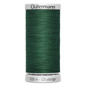 A spool of Gütermann thread, colored dark green, labeled "100 m - 110 yds/vgs." The brand name is printed at the top on a white spool. The thread is tightly wound around the spool.