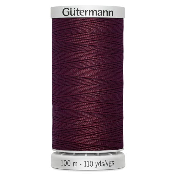 A spool of Gütermann thread in dark burgundy, labeled with "100 m - 110 yds/vgs" at the base.