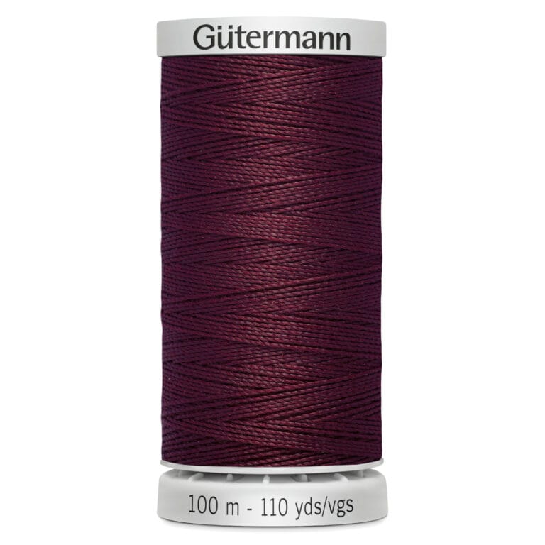 A spool of Gütermann thread in dark burgundy, labeled with "100 m - 110 yds/vgs" at the base.