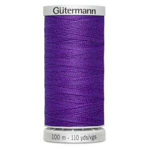 A spool of Gütermann sewing thread in a vibrant purple color, with a label indicating 100 meters or 110 yards. The spool has a white base and top.