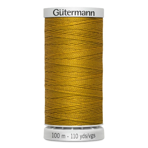 A spool of Gütermann thread in gold color. The spool is labeled with "100 m - 110 yds/vgs" and features a white base and top. The thread is neatly wound around the spool, showcasing its vibrant hue.