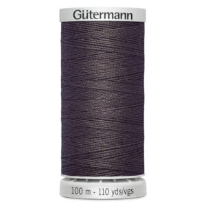 Spool of Gütermann polyester thread in a dark purple shade, labeled with "100 m - 110 yds/vgs." The spool's ends are white with the brand name "Gütermann" on top.