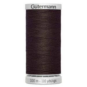 A spool of Gütermann sewing thread, dark brown in color, labeled as 100 meters or 110 yards. The spool has a white top and bottom.